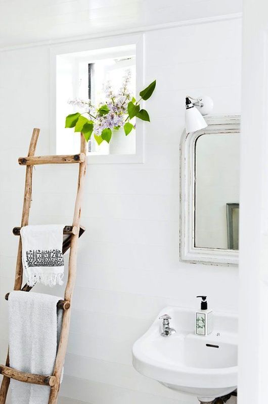 Chic take on an old ladder--turn it into a towel rack.