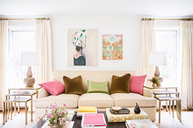 Lovely work by McGrath II-- cream sofa and curtains, gold curtain rods and tiered end tables, colorful throw pillows. 