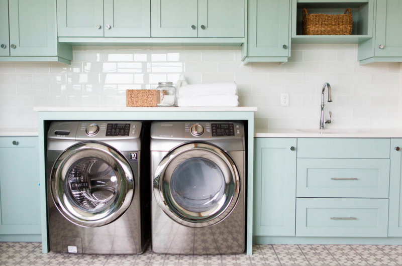 This dreamy laundry room, with its mint cabinetry, white subway tiling, and square footage is going to give you serious design-envy. 