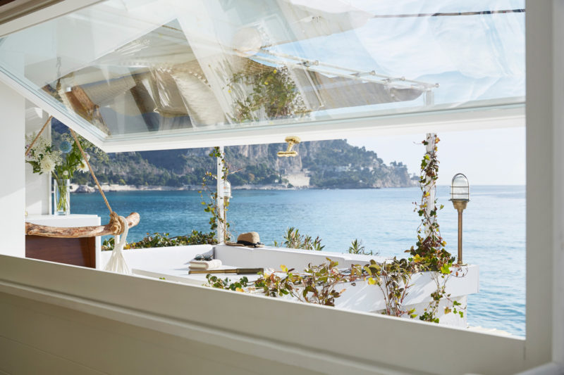 You won't want to miss the tour of this tiny seaside cottage...white walls, brass fittings, Carrara marble, and that view!