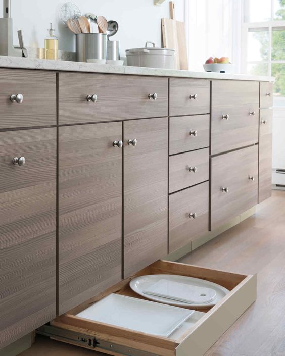 Add to the list of dream kitchen design features: the toe kick drawer. 