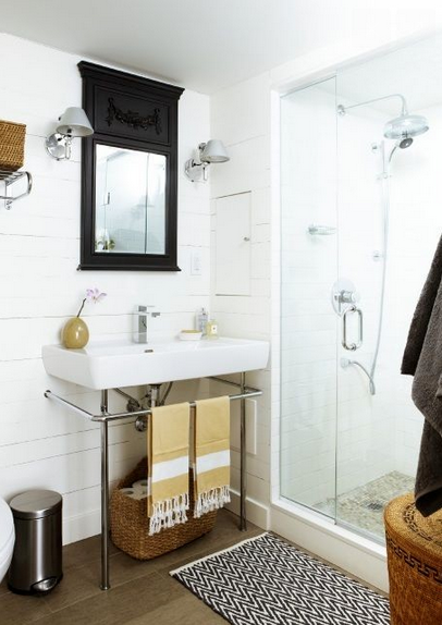 Cottage-Style Basement Bathroom-  A black mirror pops in this white space.