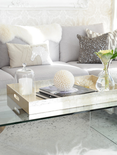 Lucite coffee table, xl gold tray, perfect accessories, light grey sofa. 