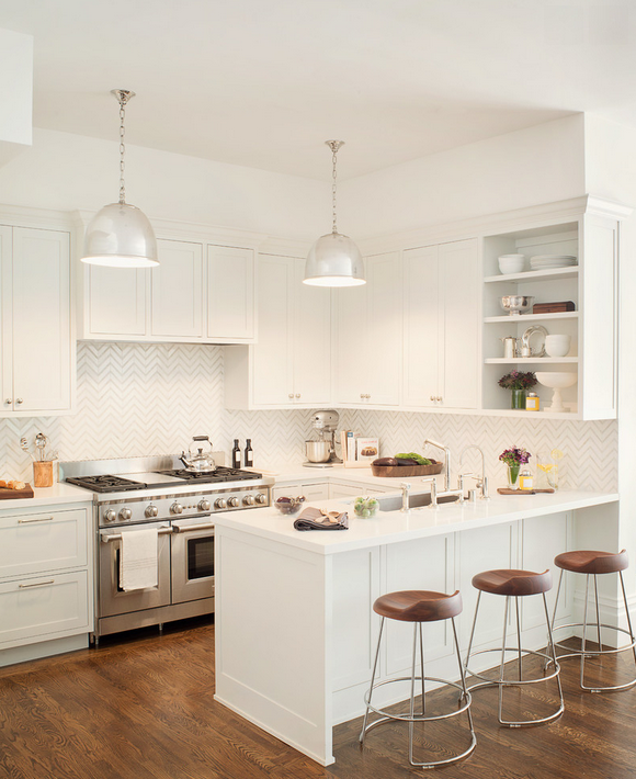 Gorgeous white kitchen with herringbone backsplash and wood floors 