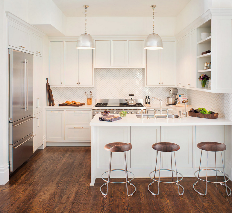 Gorgeous white kitchen with herringbone backsplash and wood floors 