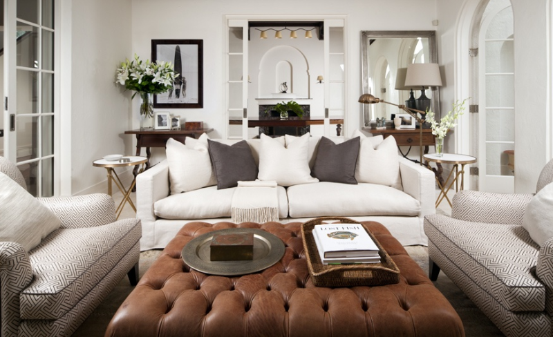 Amazing design by Coco Republic; white sofa, brown leather tufted ottoman, subtle but graphic chairs, and gold side tables to boot.  