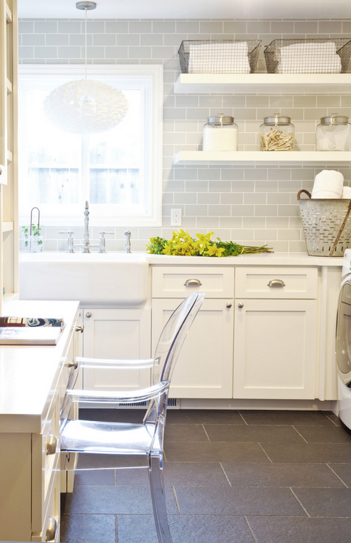 Perfect laundry room--open space, shelving, subway tiling, farmhouse sink, durable tile floors and a workspace to boot! 