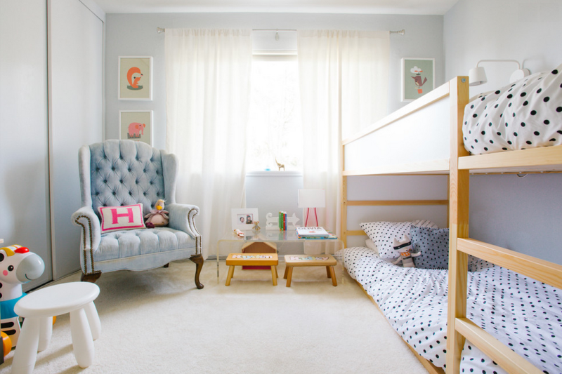 Totally charming kid's bedroom with bunk beds and fun framed prints. 