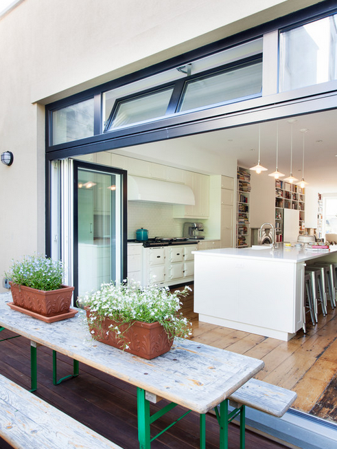 This row house is too good to be true! Kitchen opens up directly to the patio.
