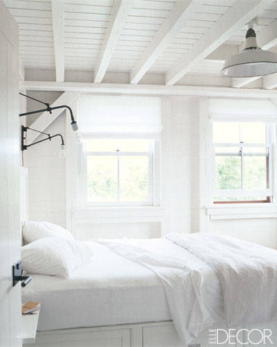 Beach house all-white guest bedroom with perfectly simple roman shades.
