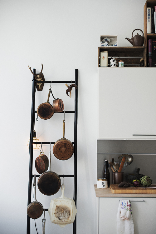 Great idea for kitchens without much drawer or cupboard space: use an old ladder to hang pots and pans! 