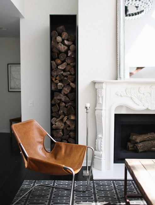 Sculptural firewood container stores logs and adds a fantastic rustic vibe to this space. 