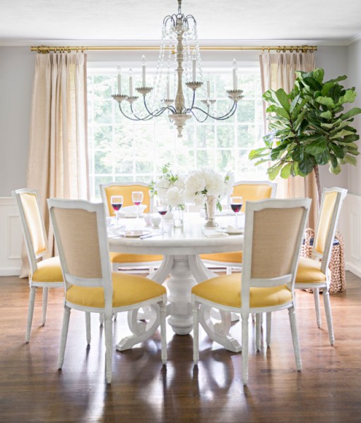The beautiful design work of McGrath II--dining space with marble-topped round table and yellow chairs.