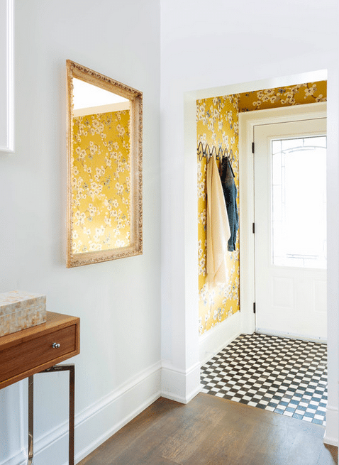 Cheery entryway by Meghan Carter Design Inc. with checkerboard floor.