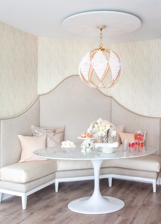 Banquette, marble table, and the most beautiful light fixture from Peridot Decorative Homewear.