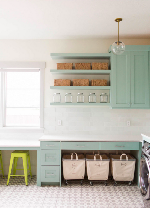 This dreamy laundry room, with its mint cabinetry, white subway tiling, beautifully tiled floor (and square footage!) is going to give you serious design-envy. 