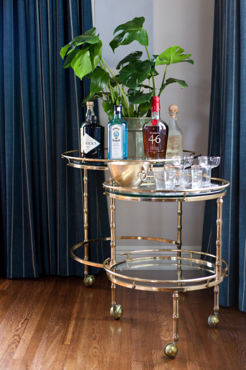 Spotlight on Taylor Jacobson Interior Design--heavy, dramatic curtains and a perfectly vintage brass bar cart.