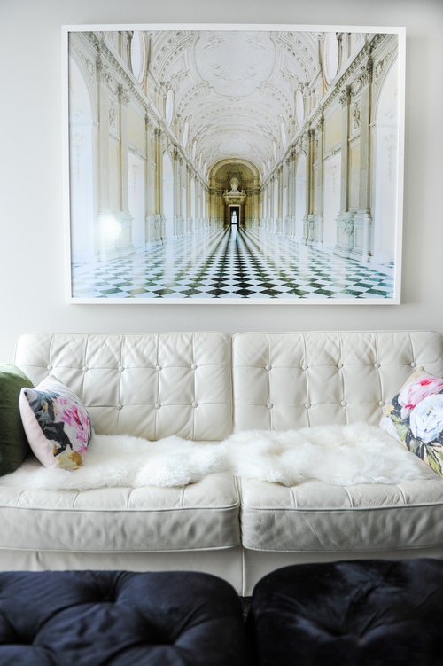 White leather done right! Love this classic white leather sofa with David Burdeny dramatic print of Reggia di Venaria Reale.