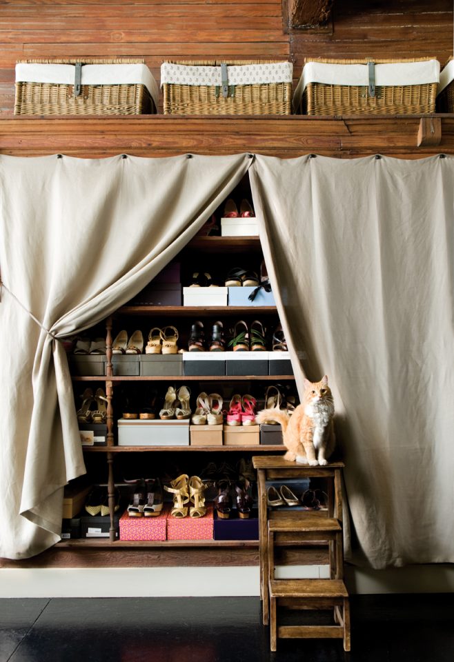 Use curtains to create concealed storage. Obvious in the best way. 