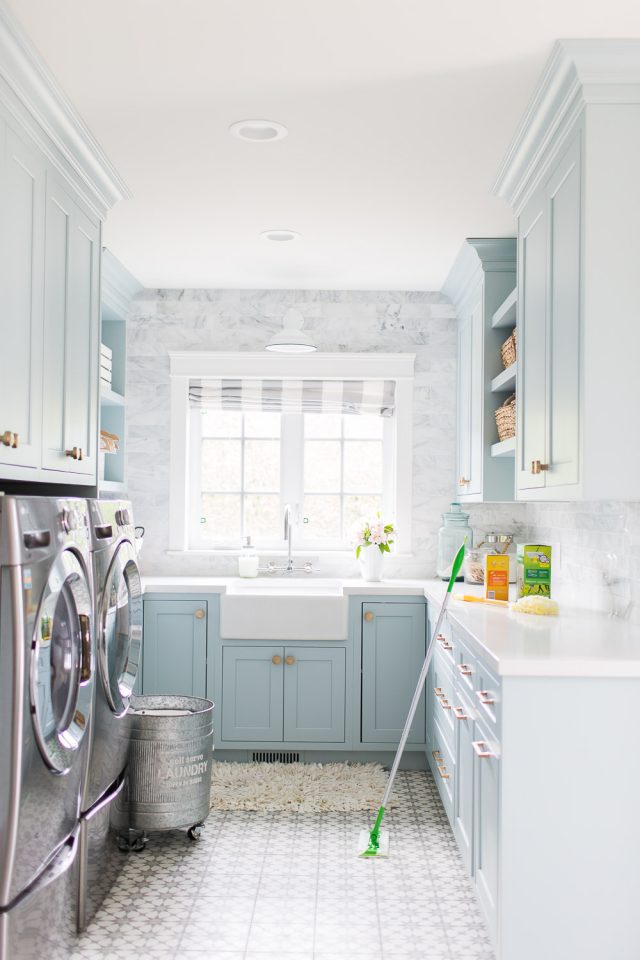 Seriously dreamy laundry room design. Blue cabinets, beautiful tile, stunning fixtures.  