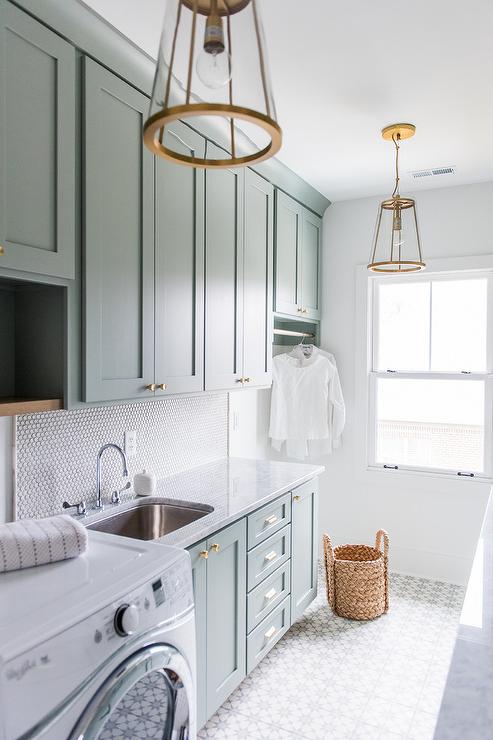 Seriously dreamy laundry room design. Mint cabinets, beautiful tile, stunning fixtures.  